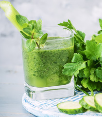Smoothies of green vegetables and various green vegetables around. Cocktail of vitamins cleansing, detox of the body.
