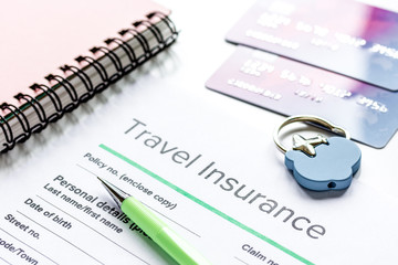 Travel insurance application form on white desk background