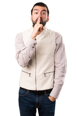 Handsome man with vest making silence gesture on isolated white background