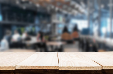 Selected focus empty brown wooden table and Coffee shop or restaurant blur background with bokeh image. for your photomontage or product display.