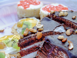 Big slice of the chocolate cake on the dessert table close-up