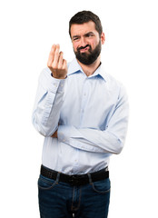 Naklejka premium Handsome man with beard making money gesture