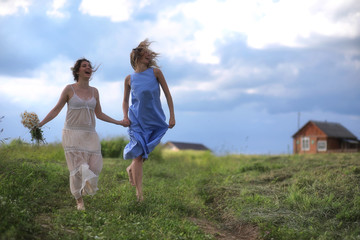 Young girls are walking in the field