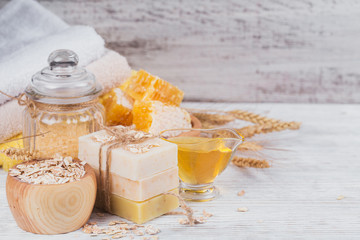 Fototapeta na wymiar Honeycomb, sea salt, oats and handmade soap with honey