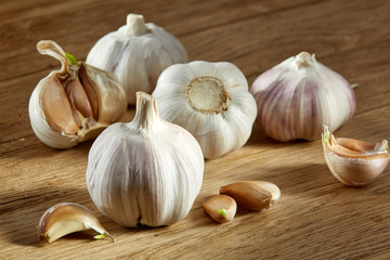 Garlic close up on wooden plate on rustic background, shallow depth of field, selective focus, macro