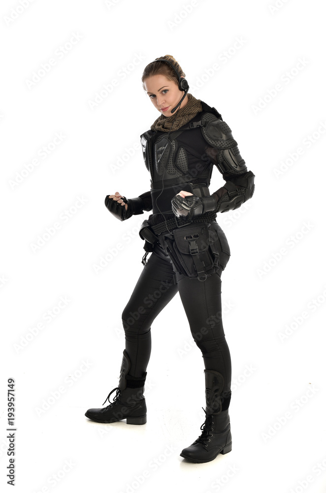 Canvas Prints full length portrait of female  soldier wearing black  tactical armour, isolated on white studio background.