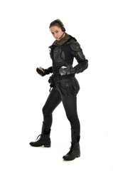 full length portrait of female  soldier wearing black  tactical armour, isolated on white studio background. © faestock