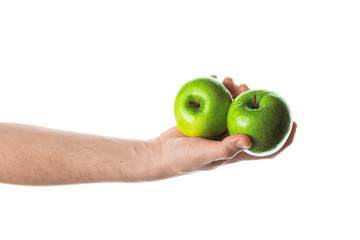 Man holding two green apples in his hand. Isolated on white background.