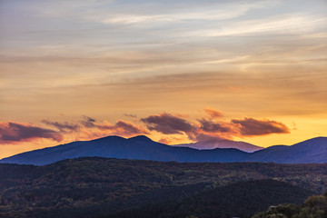 Obraz na płótnie Canvas sunset landscape behind hills 