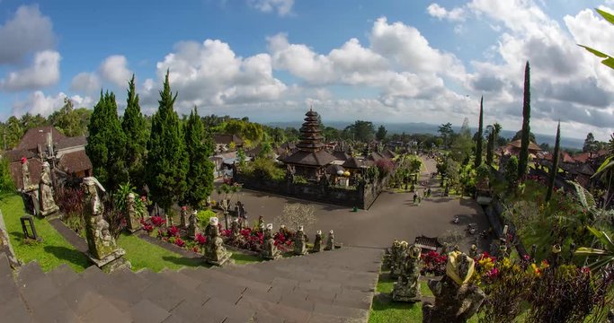 timelapse of Pura Besakih temple in bali with clouds passing by on a sunny day