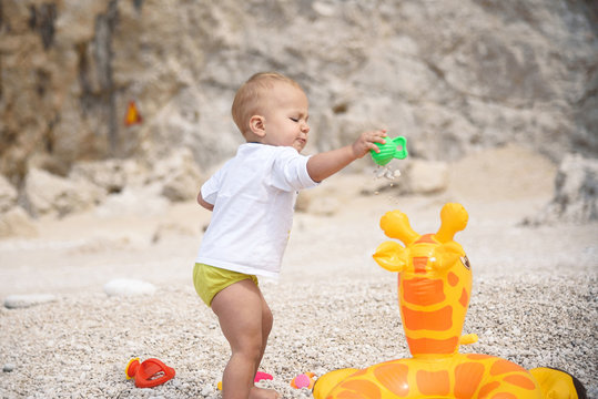 Boy Playing with Stones and Air Jiraffe