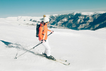 Fototapeta na wymiar Young woman Skier skiing in winter mountains