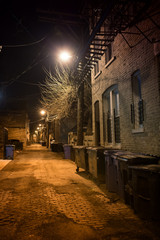 Dark empty and scary urban city street cobblestone.alley and vintage buildings at night