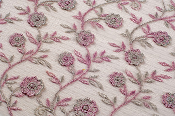 Texture, background, pattern. Pink lace decorated with flowers on a white background. Background of pink lace fabric beautifully decorated with flowers - obrazy, fototapety, plakaty