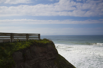 observation deck on the cliff above the blue ocean in sunny weather
