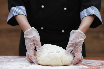 the cook makes flour for baking on the table