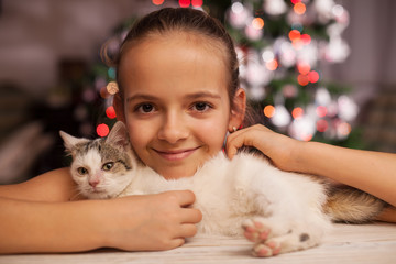 Fototapeta na wymiar Young girl with the perfect christmas gift - a rescued kitten