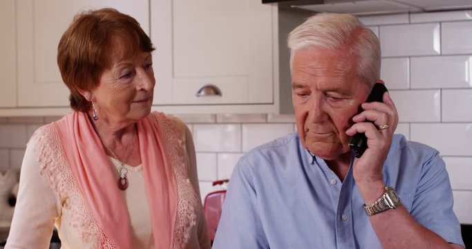 4k, You have a call.. Old couple receive a phone call on their mobile phone.