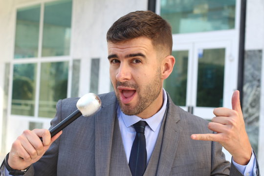 Businessman holding a microphone in office space