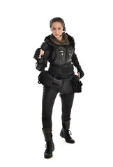 full length portrait of female  soldier wearing black  tactical armour, isolated on white studio background.