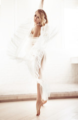Fototapeta na wymiar Beautiful young woman dancing in studio, soft portrait.
