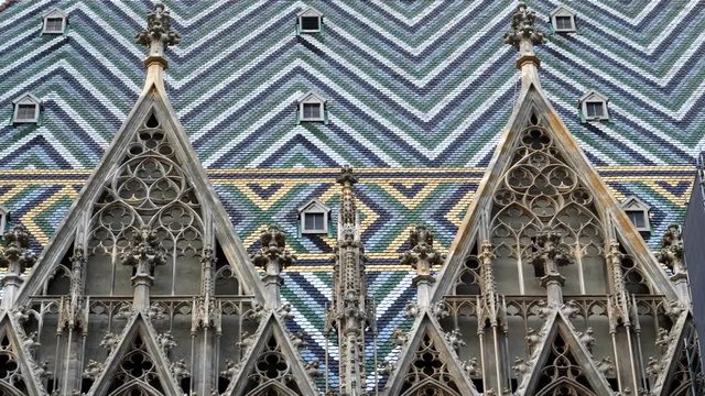 a close up tilt down view of the outside of st stephen's cathedral in vienna, austria