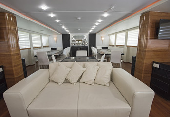 Interior of large salon area of luxury motor yacht