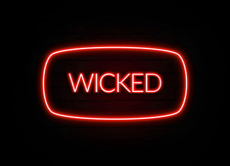 Wicked neon sign on brick wall background.