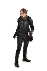 Fototapeta premium full length portrait of female soldier wearing black tactical armour, isolated on white studio background.