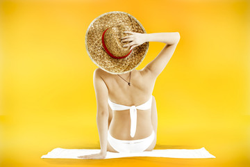 woman in bikini on orange background 