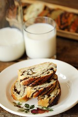 Fresh baked poppy seed roll and milk on the table 