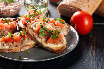 Appetizer bruschetta with tuna, mozarella cheese and tomatoes