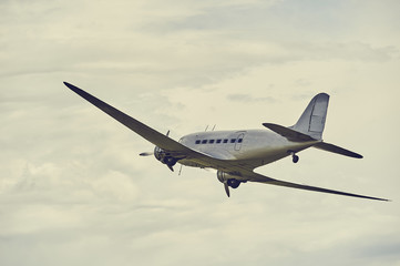 Old propeller airliner flying
