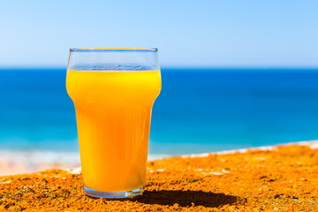 Glass filled with orange juice at sea