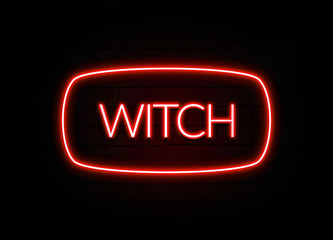 Witch neon sign on brick wall background.