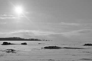 Winter sun, field and forest