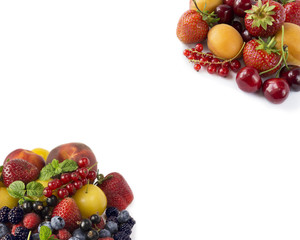 Sweet and juicy fruits at border of image with copy space for text. Ripe apricots, currants, cherries, strawberries, blackberries, bluberries, peaches and yellow plums. Top view.