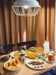 Pancakes with salmon fish and tea kettle on table in cafe. Table with tasty food.