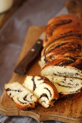 Fresh baked poppy seed roll on the table  