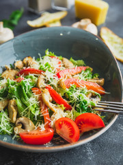 Salad with mushroom, cheese, lettuce and pepper in a plate. Closeup view