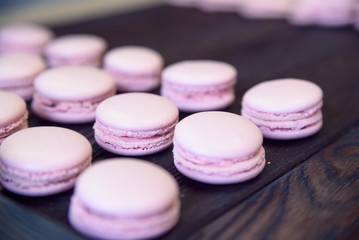 Obraz na płótnie Canvas Pink macarons on wooden table