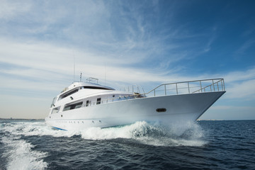 Luxury private motor yacht sailing at sea - obrazy, fototapety, plakaty