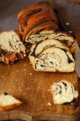 Fresh baked poppy seed roll on the table   