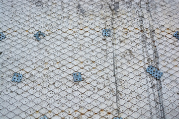 Plaster wall with metal grid mesh on it