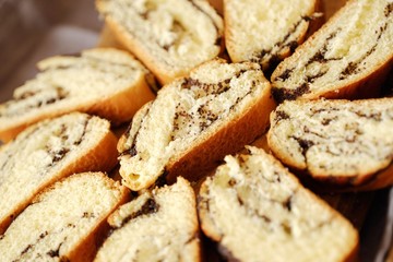 Fresh baked poppy seed roll on the table   
