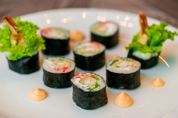 Fresh sushi rolls served on plate in restaurant