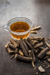 Ayurvedic herb Liquorice root,Licorice root, Mulethi or Glycyrrhiza glabra root and its powder with its tea for detoxifying the body, soothing spasms, easing menstrual cramps, raising blood pressure.