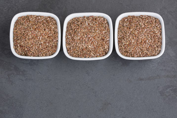 Organic flax seeds in the bowls - Linum usitatissimum