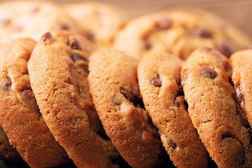 pile of homemade chocolate cookies on wooden background