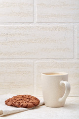 Top view closeup picture of tea in transparent cup with cookies and cotton napkin on white background, selective focus